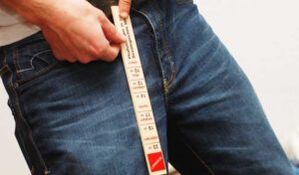 Man measuring his penis with a ruler
